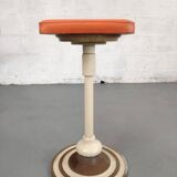 Old swivel orange sitting dentist stool