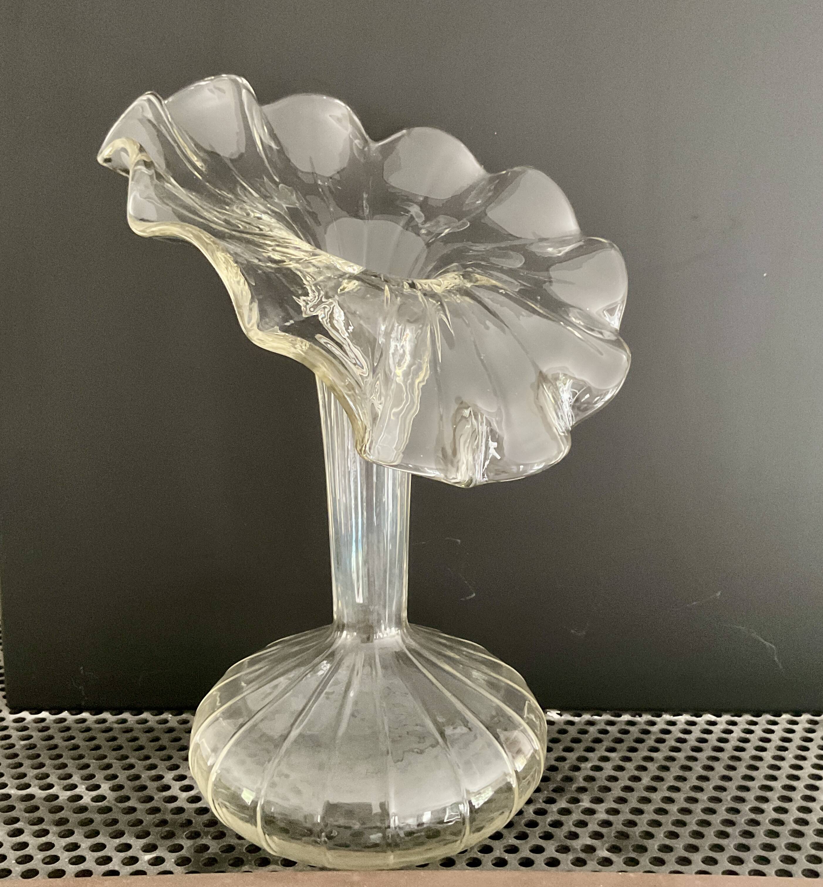 Vintage transparent glass vase in flower shape.