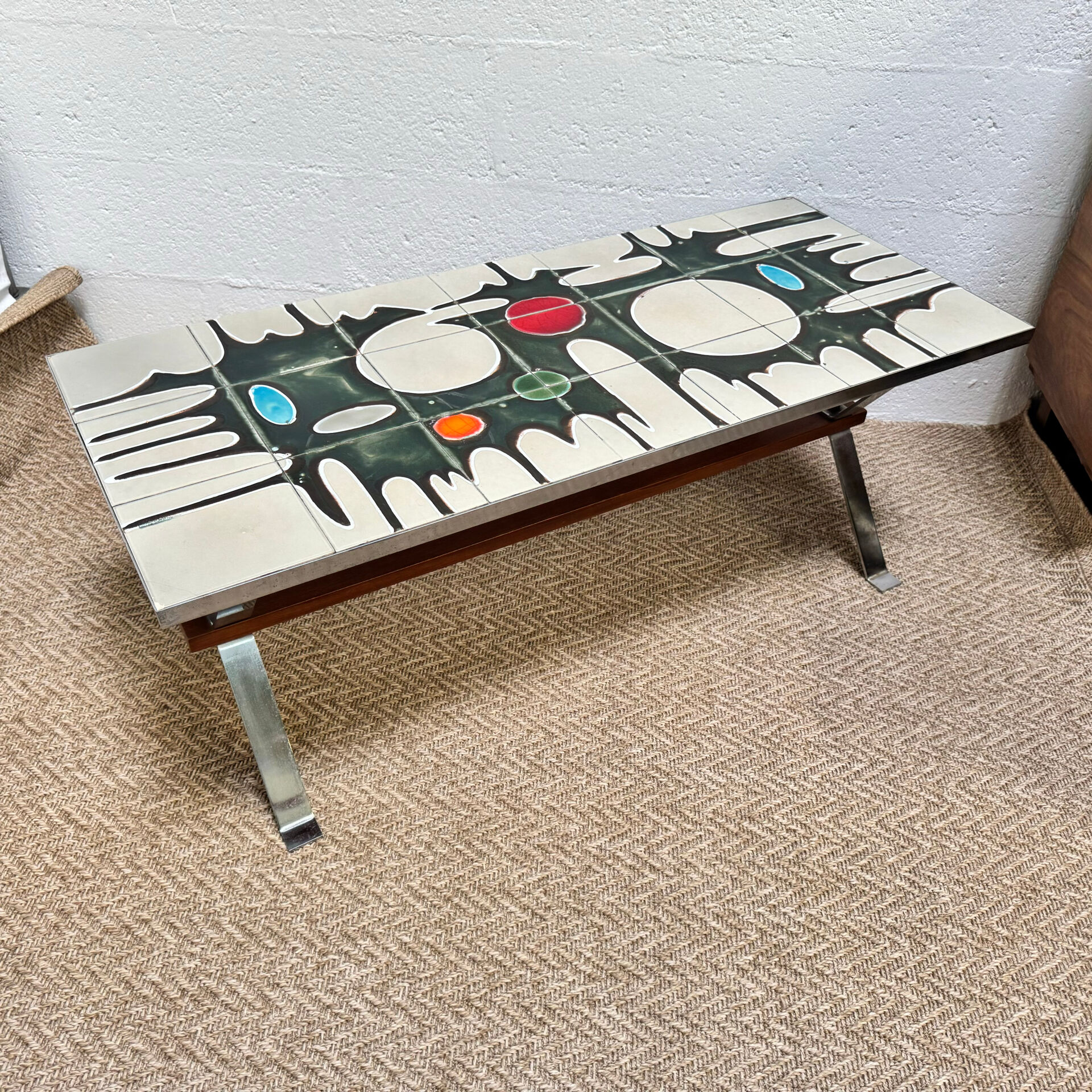 Vintage coffee table from the 60s and 70s in ceramic, chrome metal, and wood.