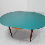 Extendable oval teak dining table