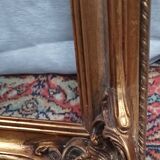 Old frame in wood and gilded stucco