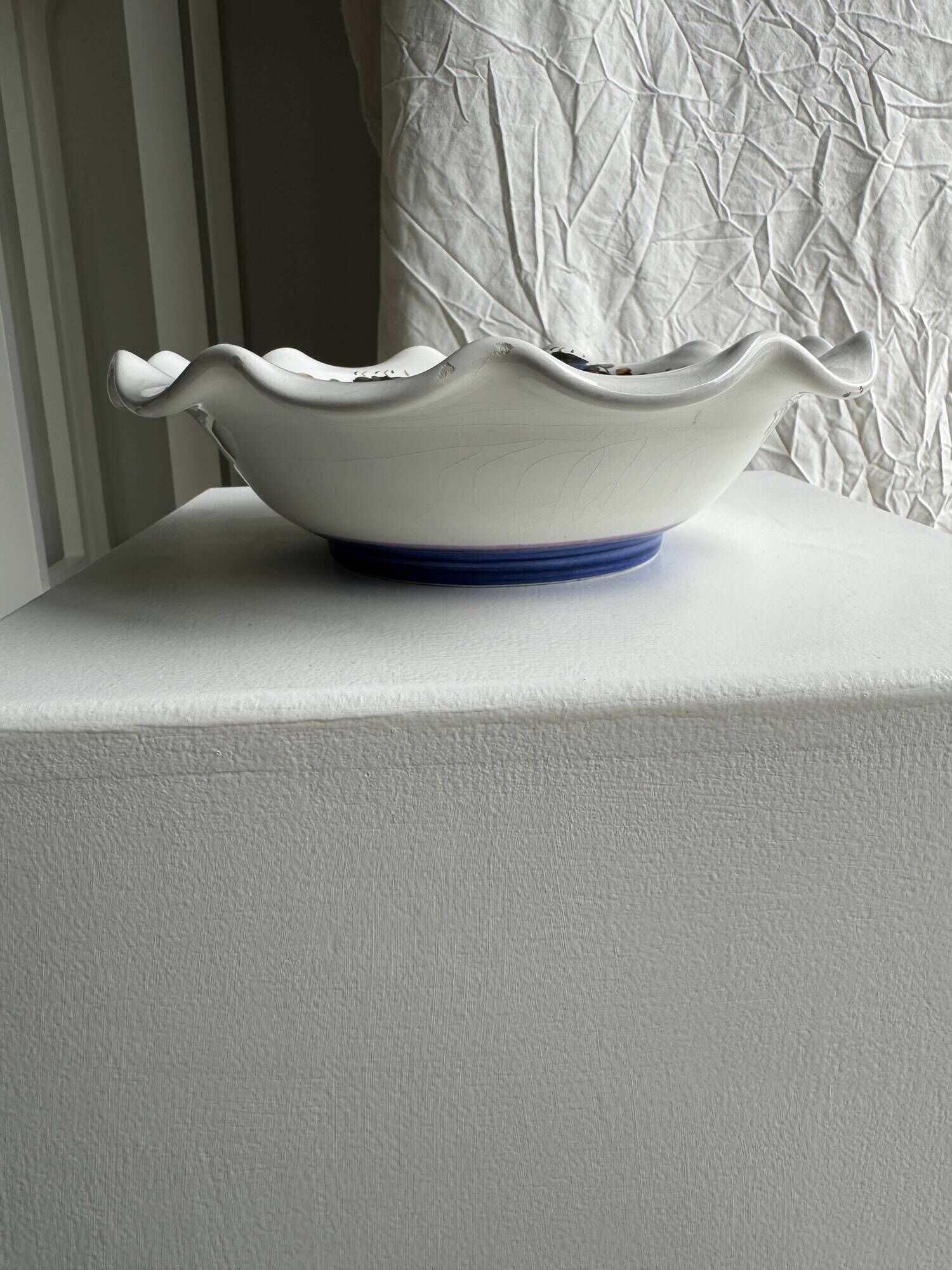 Small hand-painted earthenware salad bowl with garland of blue flowers, mark below