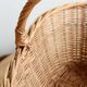 Large vintage woven wicker basket with a central handle.
