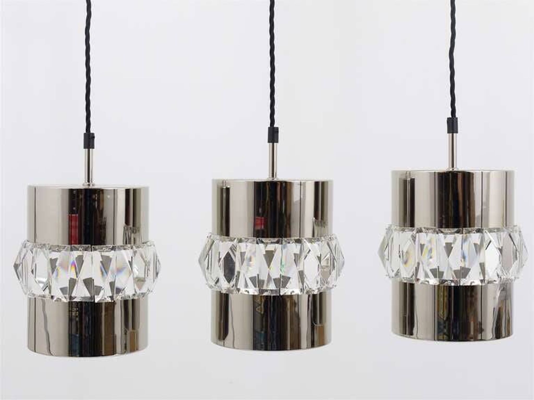 Three Bakalowits pendant lamps in nickel, brass, and faceted crystal, Austria, 1950s.