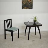 Set of 6 modernist black chairs with light blue-green ribbed fabric.