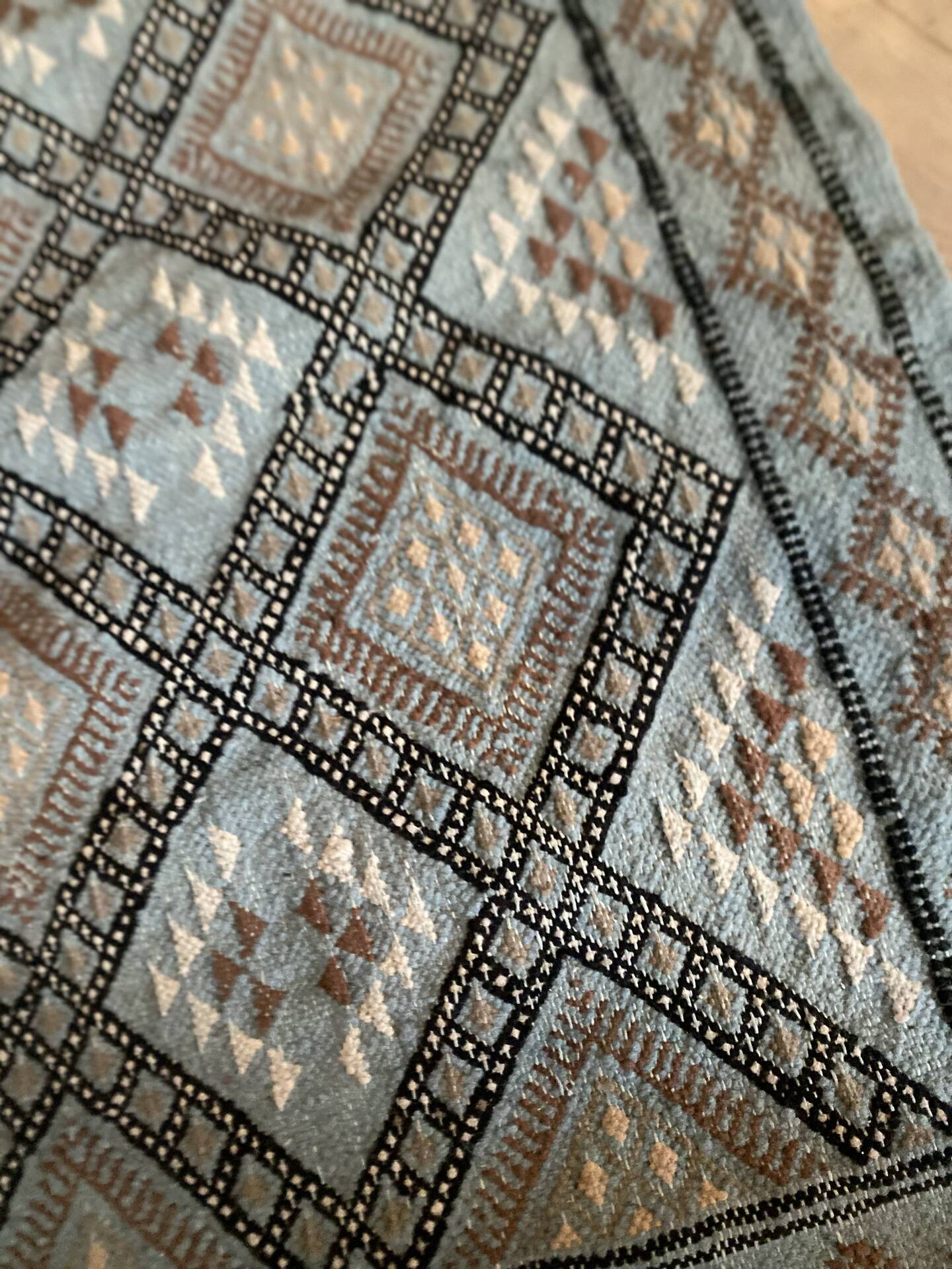 Handmade turquoise and beige wool rug, new.