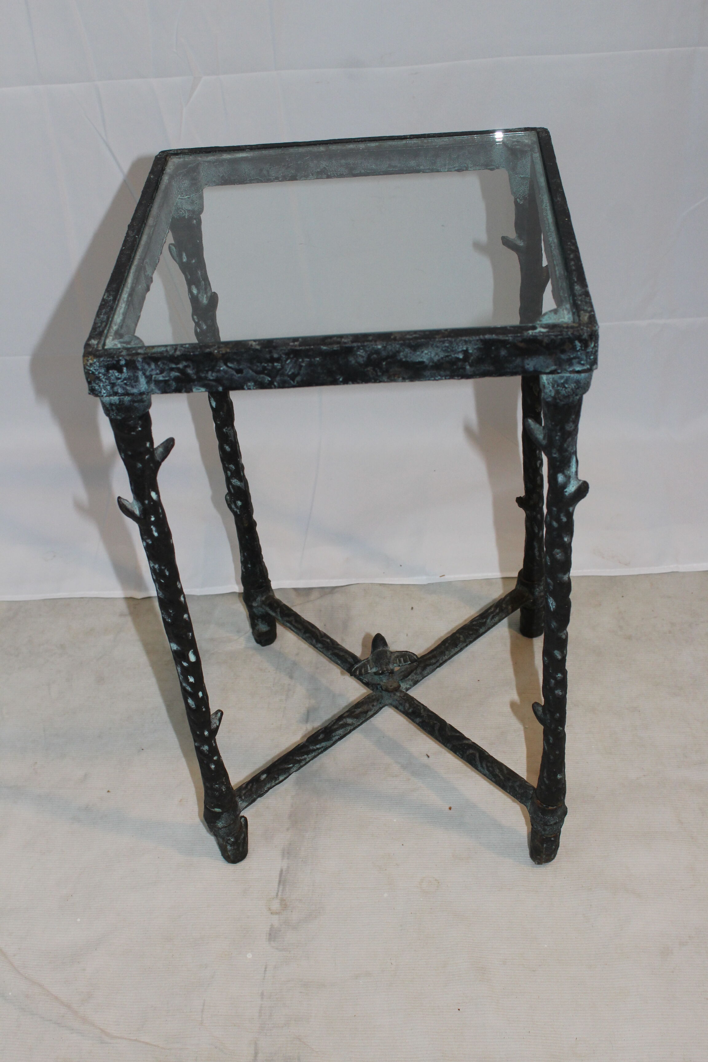 Giacometti style cast iron table, glass table