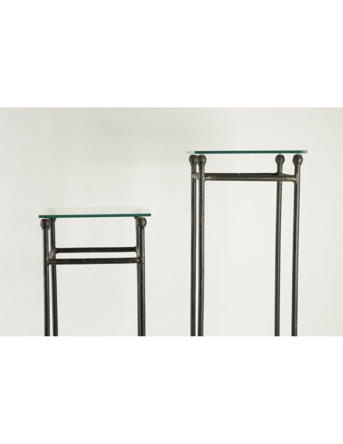 Two consoles, wrought iron sheaths on glass top, twentieth century