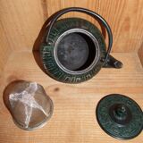 Japanese teapot in patinated green cast decorated with motifs