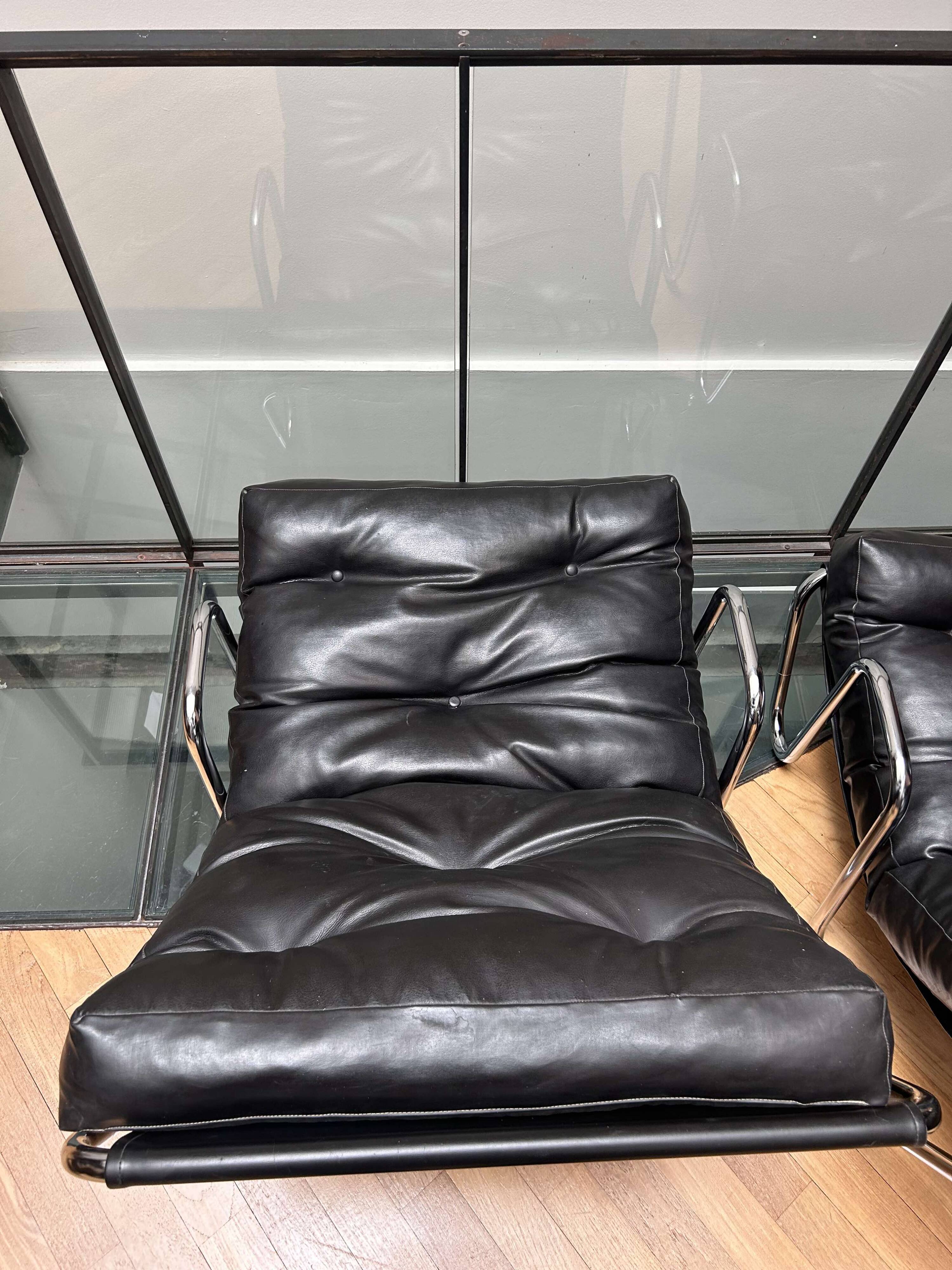 Pair of vintage armchairs in black imitation leather and chrome metal, France 1970