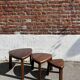 Nested tripod tables made of solid wood, in a modernist brutalist style.