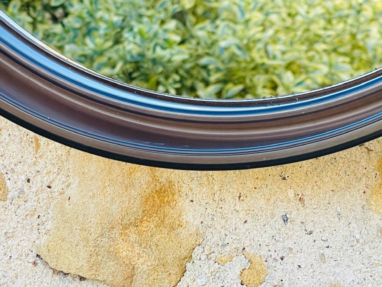 Vintage round smoked plastic mirror, circa 1970s.