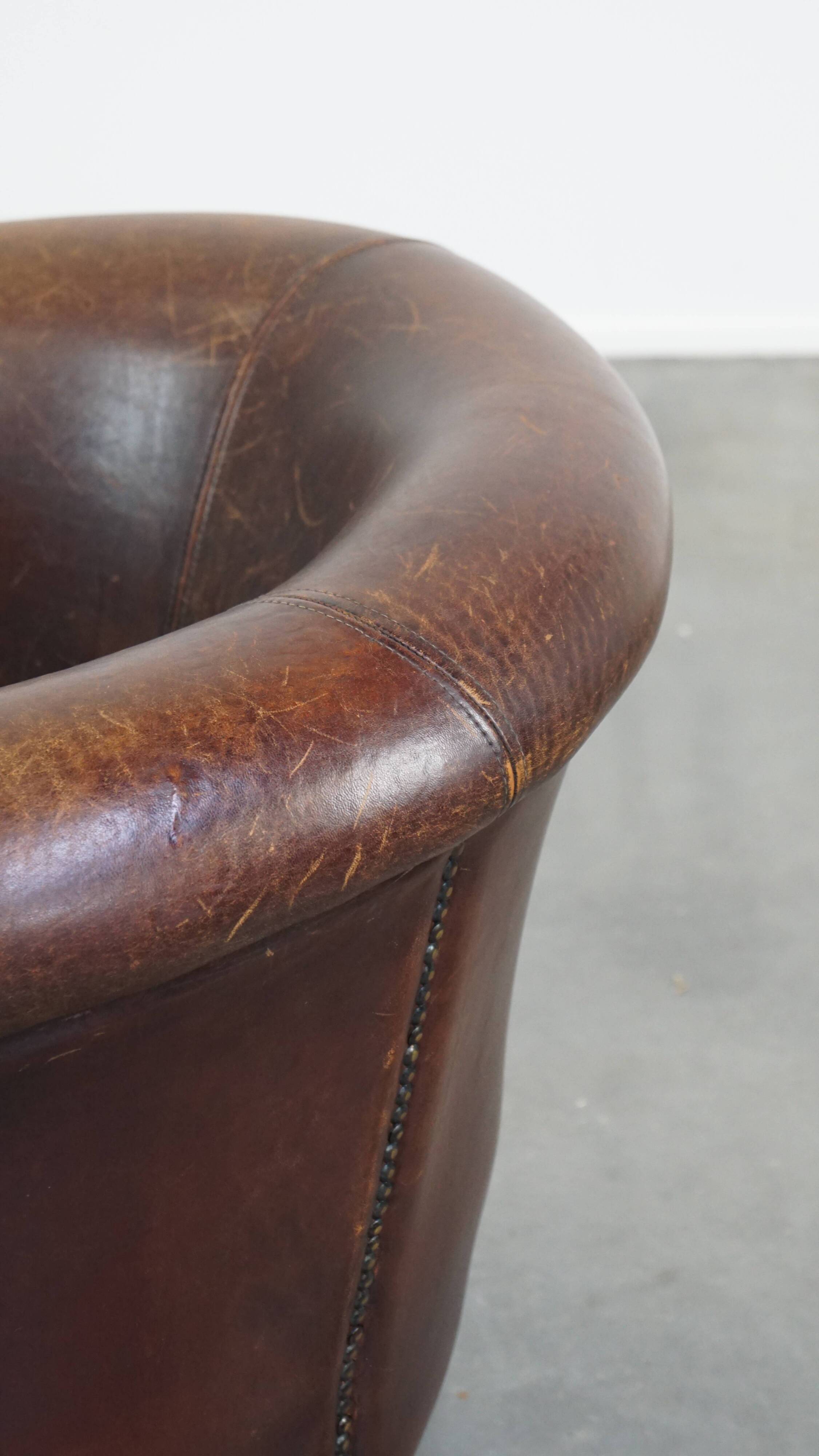 Sheep leather club chair finished with decorative nails