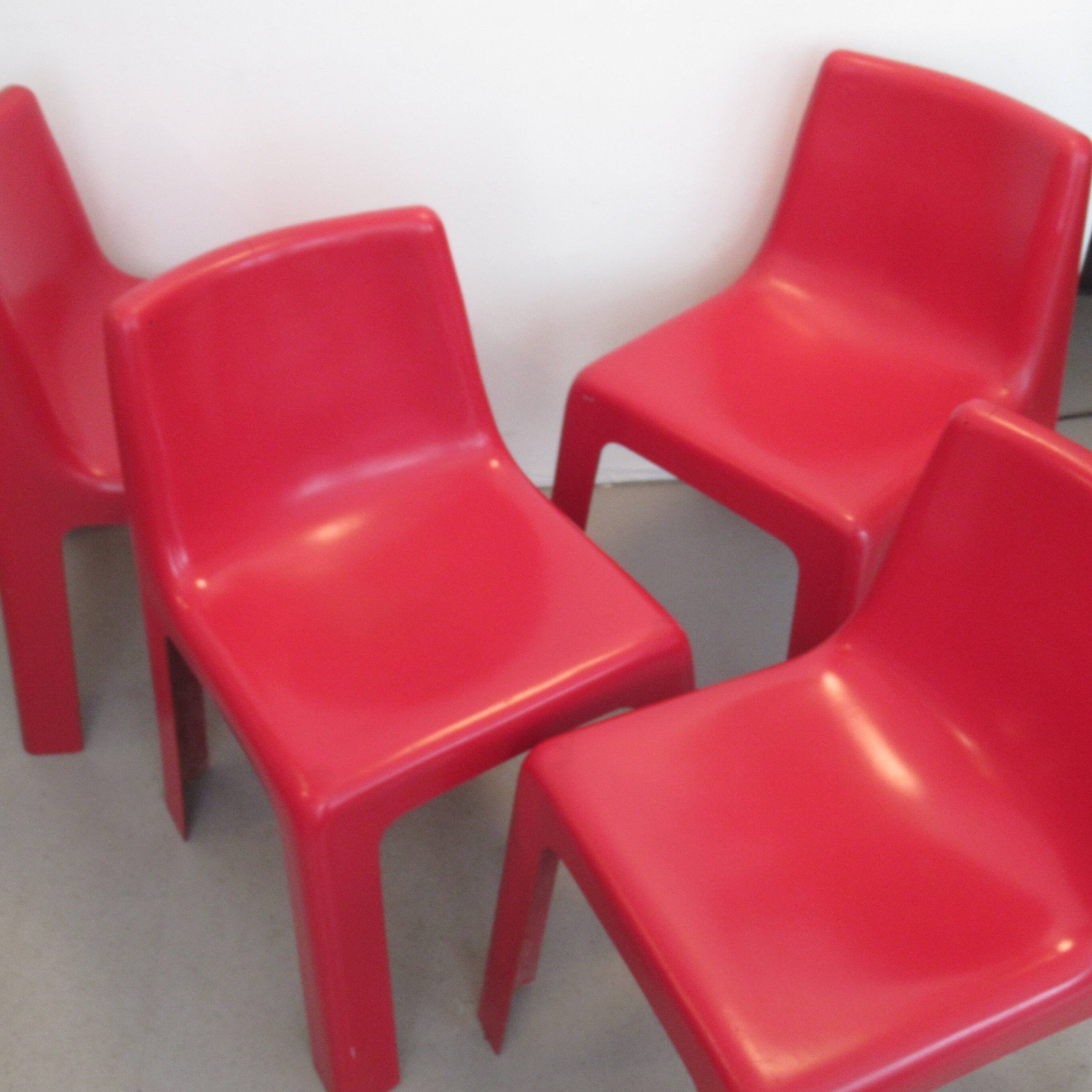 Four red fibreglass chairs from the 1970s.