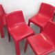 Four red fibreglass chairs from the 1970s.