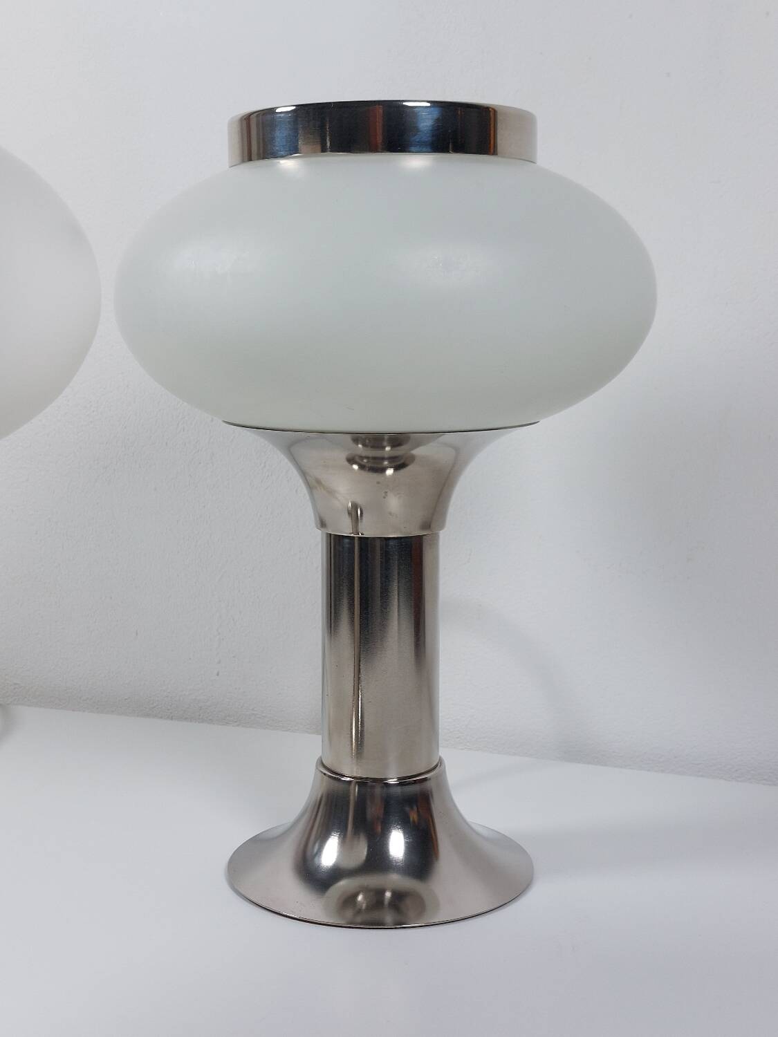Pair of vintage futuristic style table lamps in chrome and opal glass.