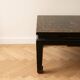 Chinese coffee table in black and gold wood.