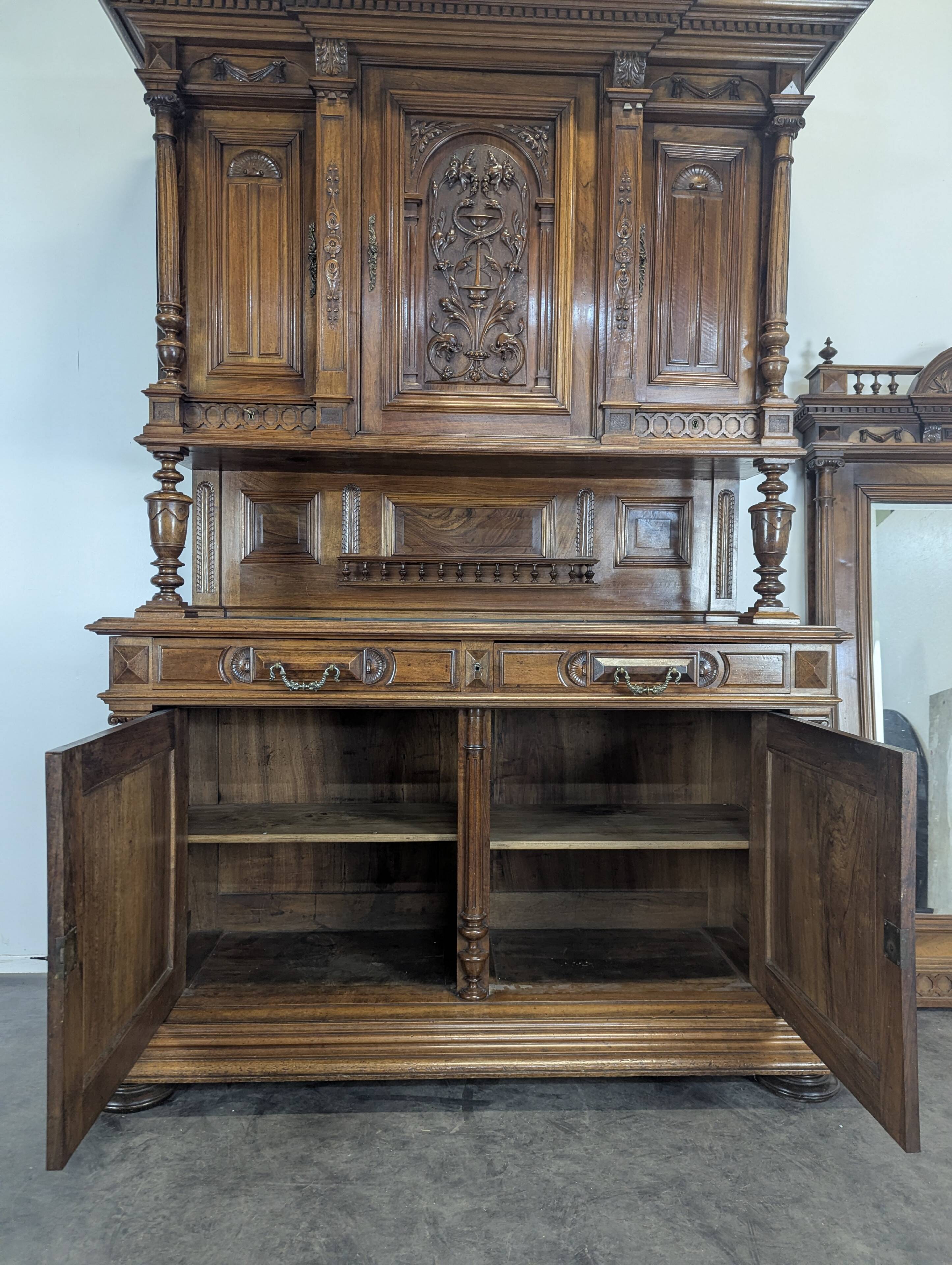 Large buffet with 2 bodies in Renaissance style made of solid walnut.