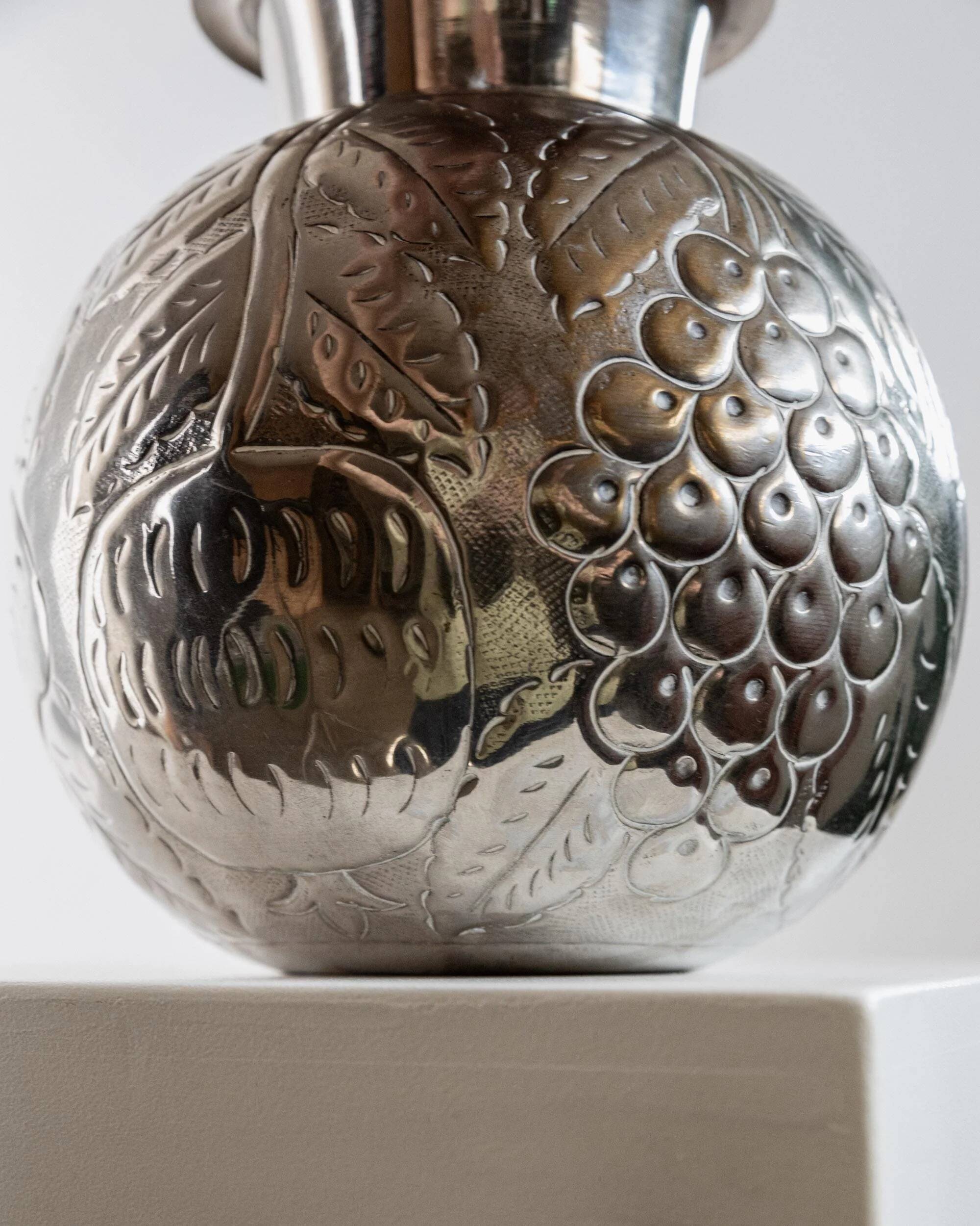 Vintage Italian vase in nickel-plated brass from the 1960s, hand-hammered relief of fruits and leaves.