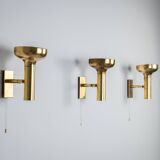 Set of three brass adjustable wall lamps
