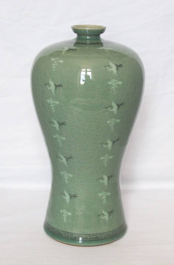 Korean vase in crackled celadon with a pattern of ducks and clouds.
