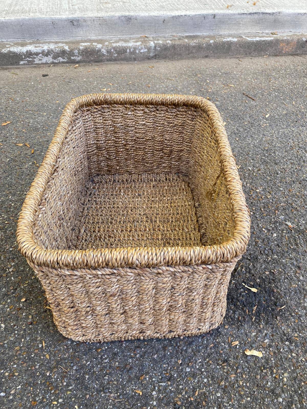 Large basket / rectangular storage bin made of woven natural fibre.