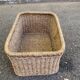 Large basket / rectangular storage bin made of woven natural fibre.