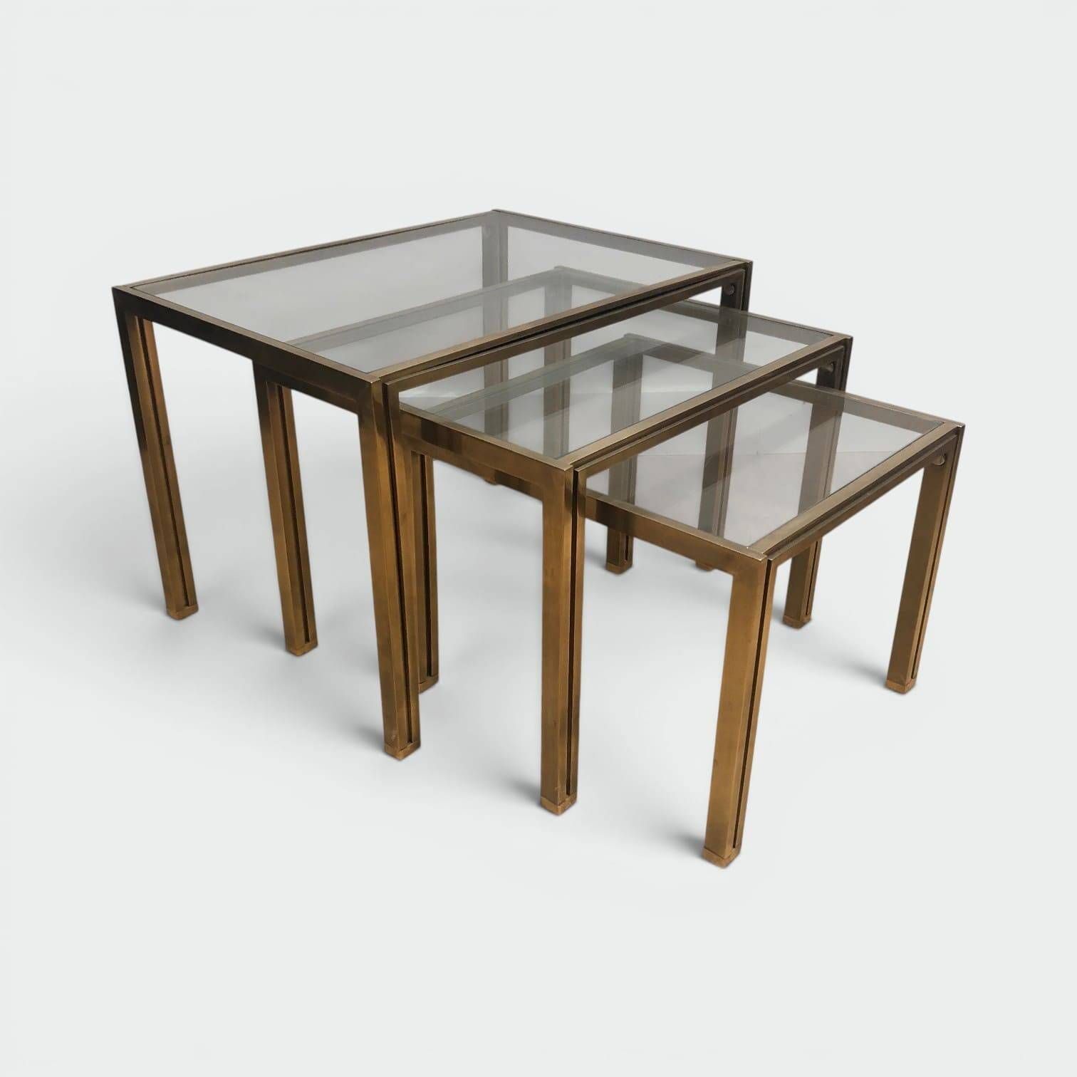 Set of 3 nesting tables in brass and glass. French work by Guy Lef.