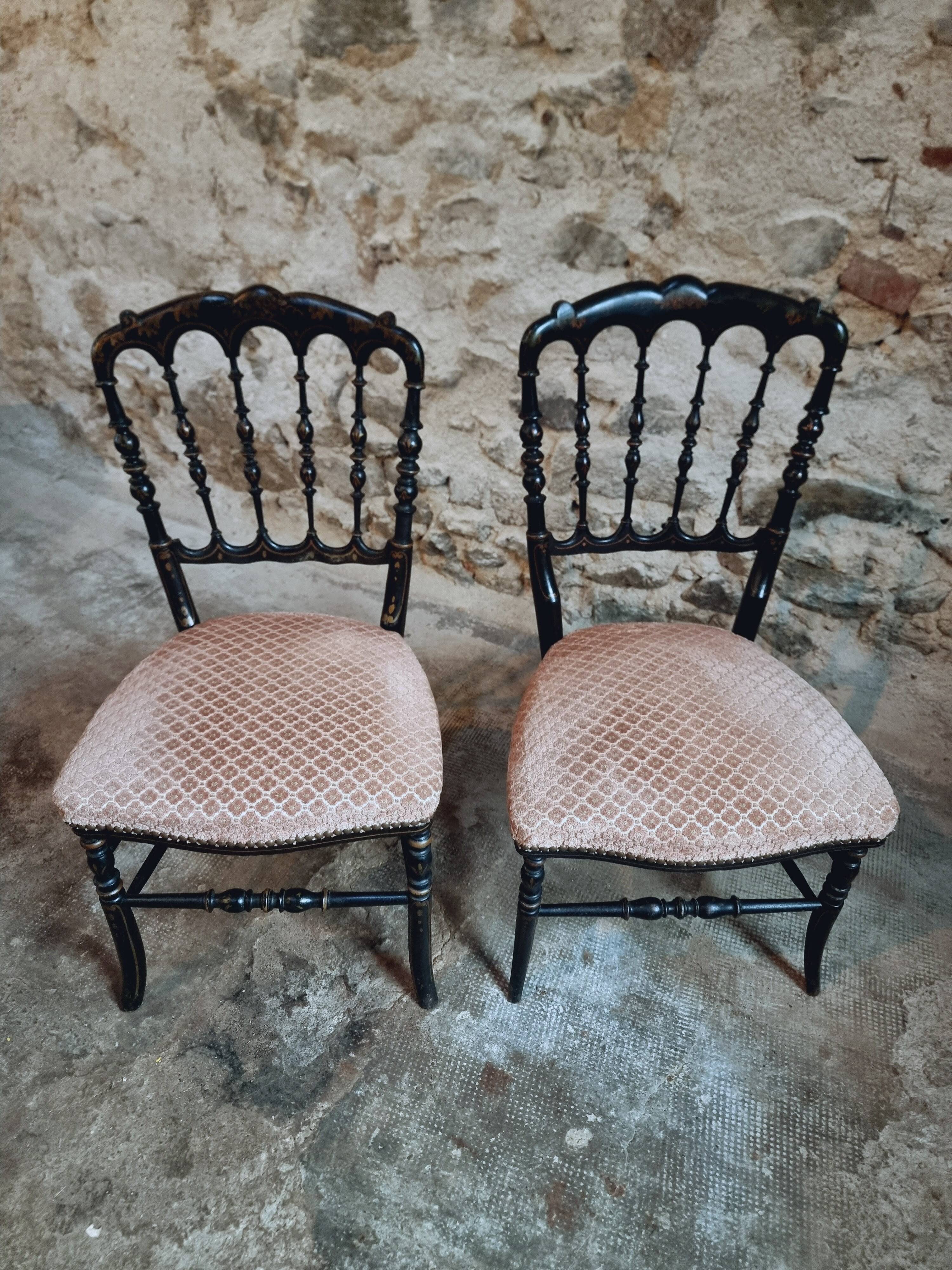 Pair of antique Napoleon III chairs in blackened wood and fabric.