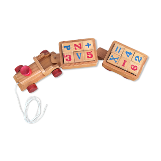 Small vintage wooden educational train on wheels