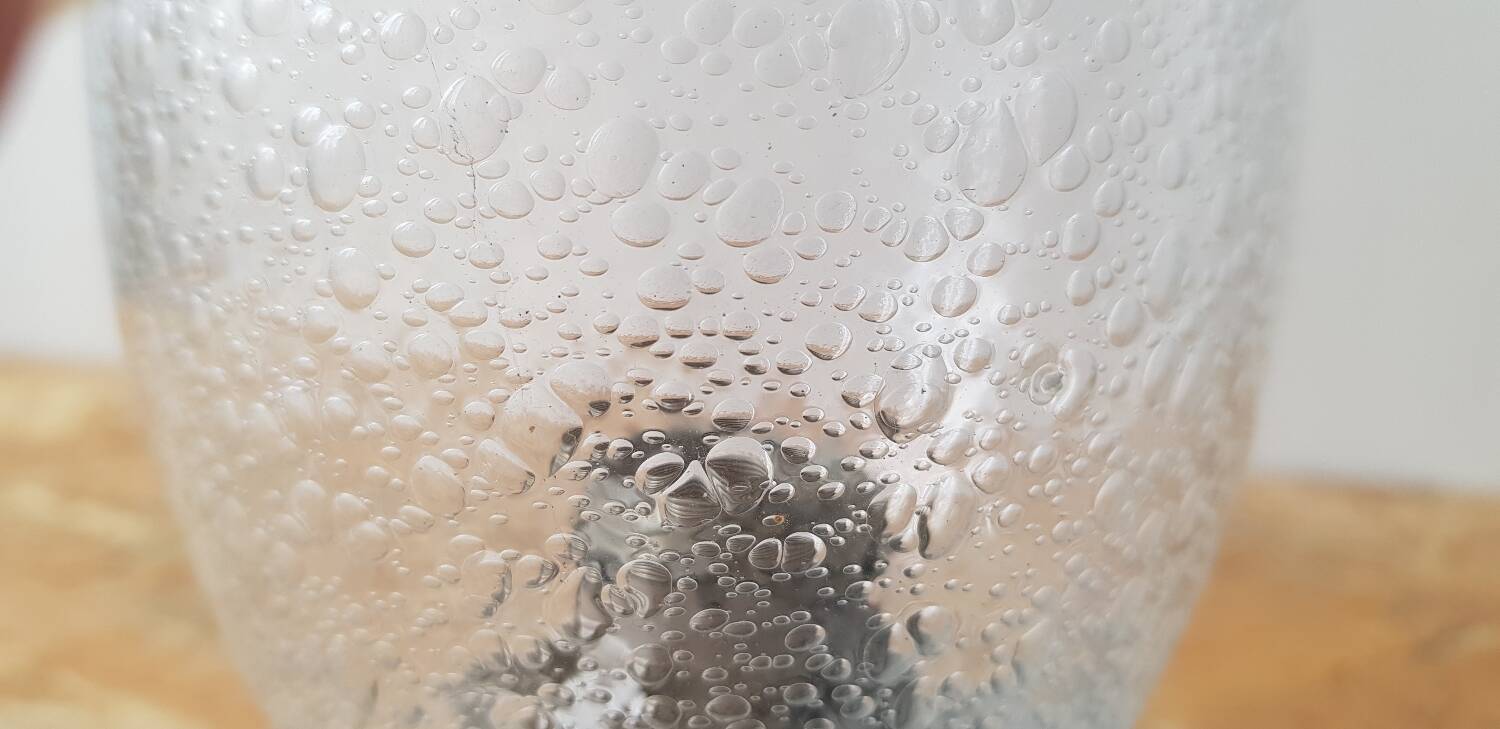 Metal and bubbled glass wall light