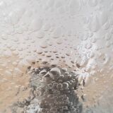 Metal and bubbled glass wall light