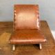 Old retro footstool, mid-century wooden leather stool, mid 20th century, European