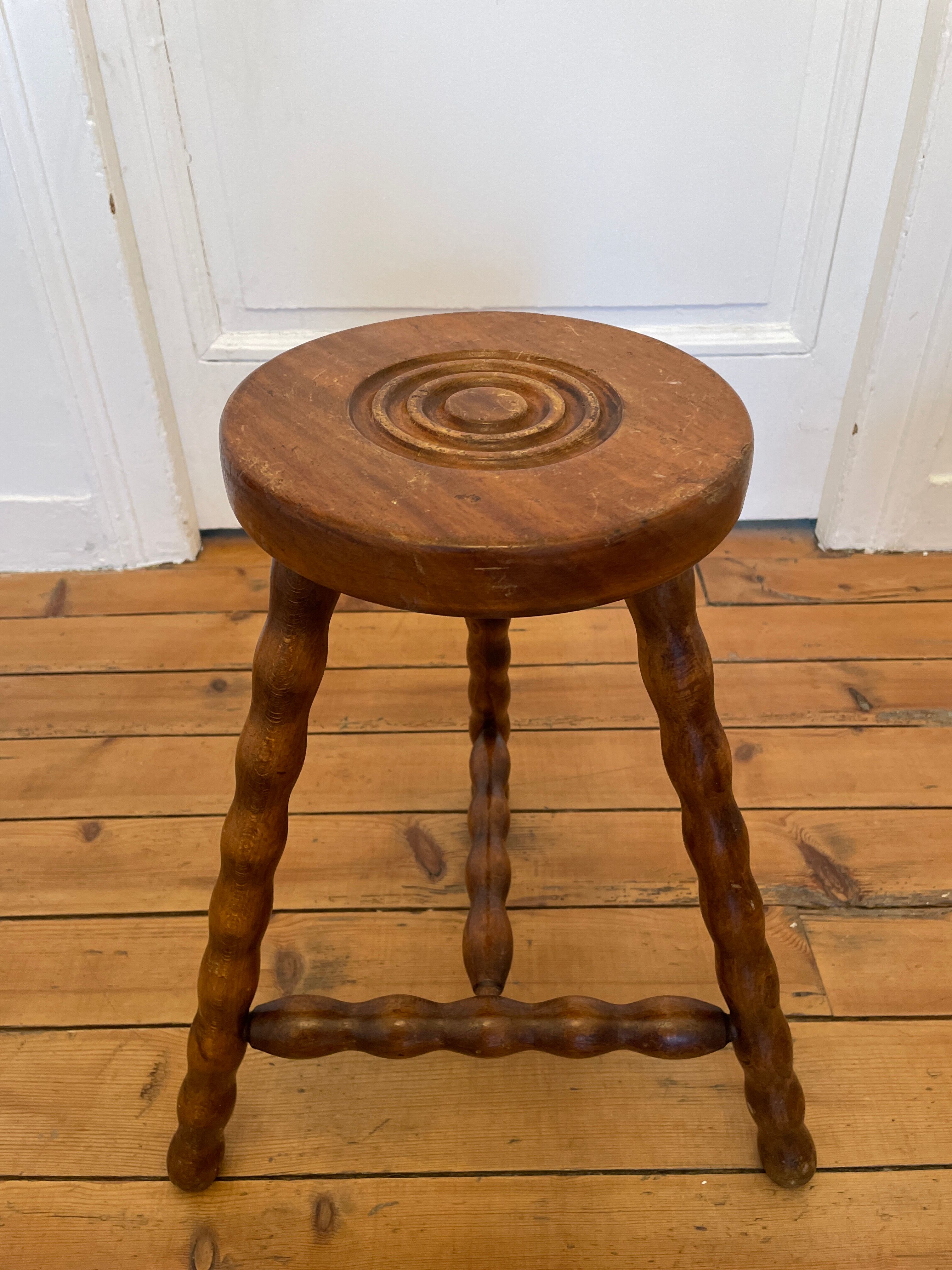 Old wooden tripod stool
