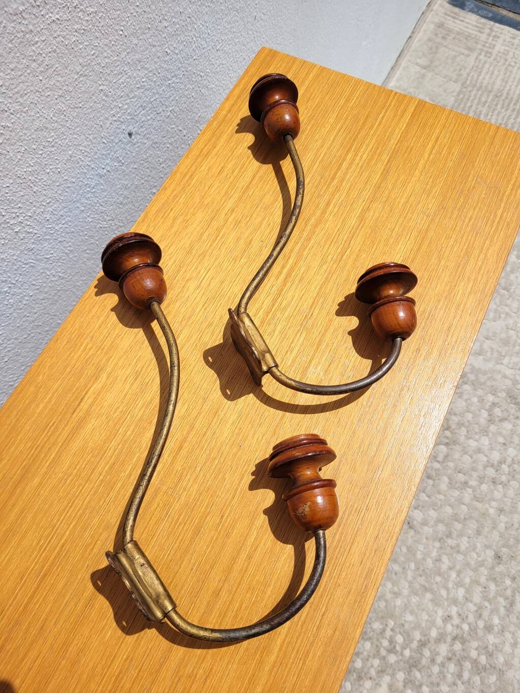 Pair of antique wooden and metal coat hooks
