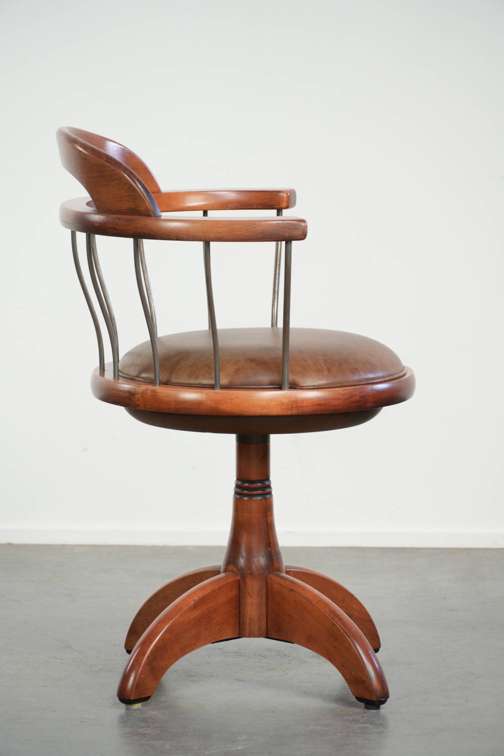 Swivel side chair / office chair with a cognac-coloured cow leather seat