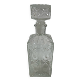 Carafe en verre moulé, années 1960-1970, décor fleurs stylisées, ovale, base carrée, bouchon, rosace