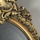 Oval gilded wooden mirror in Louis XV style, 19th century