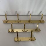 Three vintage 1960s gold coat racks 4, 3 and 2 hooks