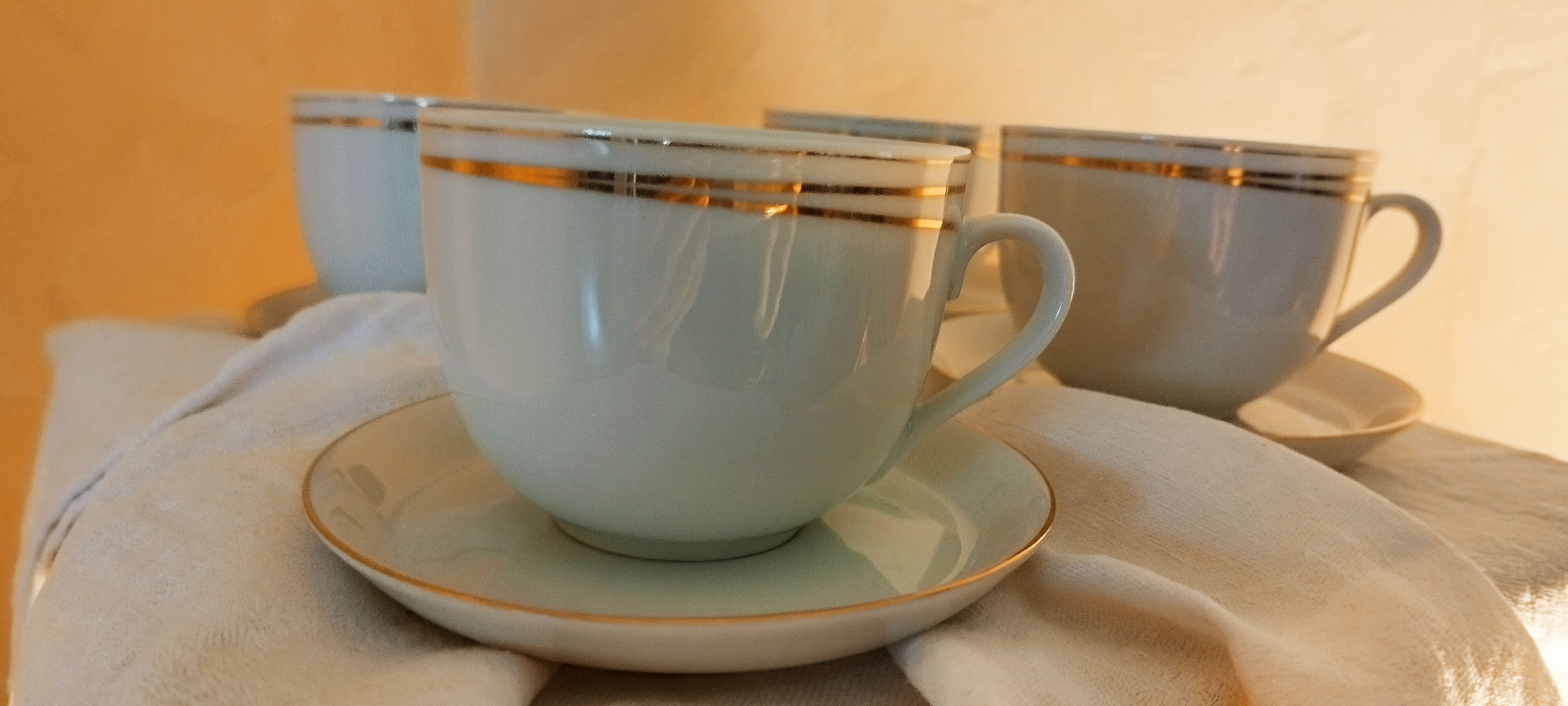 Set of 4 white and gold porcelain cups