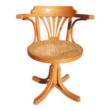 Vintage American swivel chair in wood and cane.