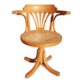 Vintage American swivel chair in wood and cane.