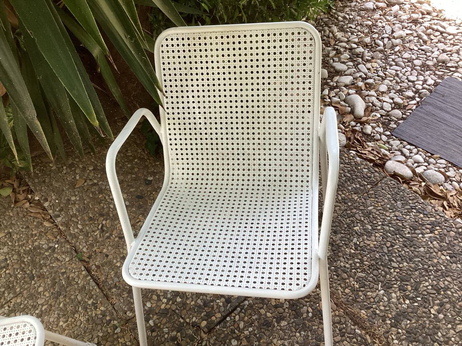 Perforated metal armchairs