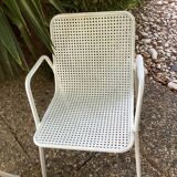 Perforated metal armchairs