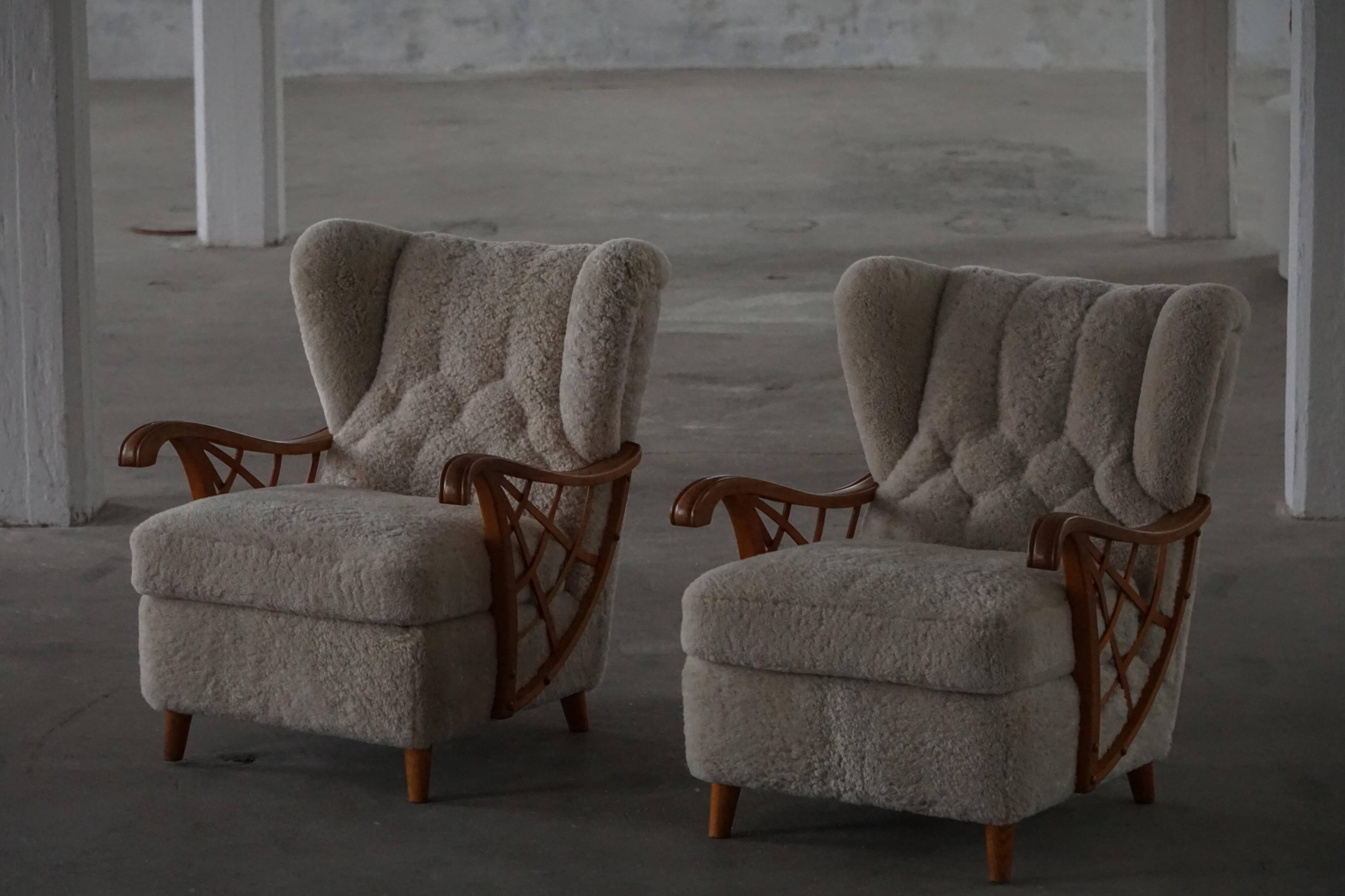 Pair of modern Swedish lounge chairs, shearling sheepskin and elm, 1940s.