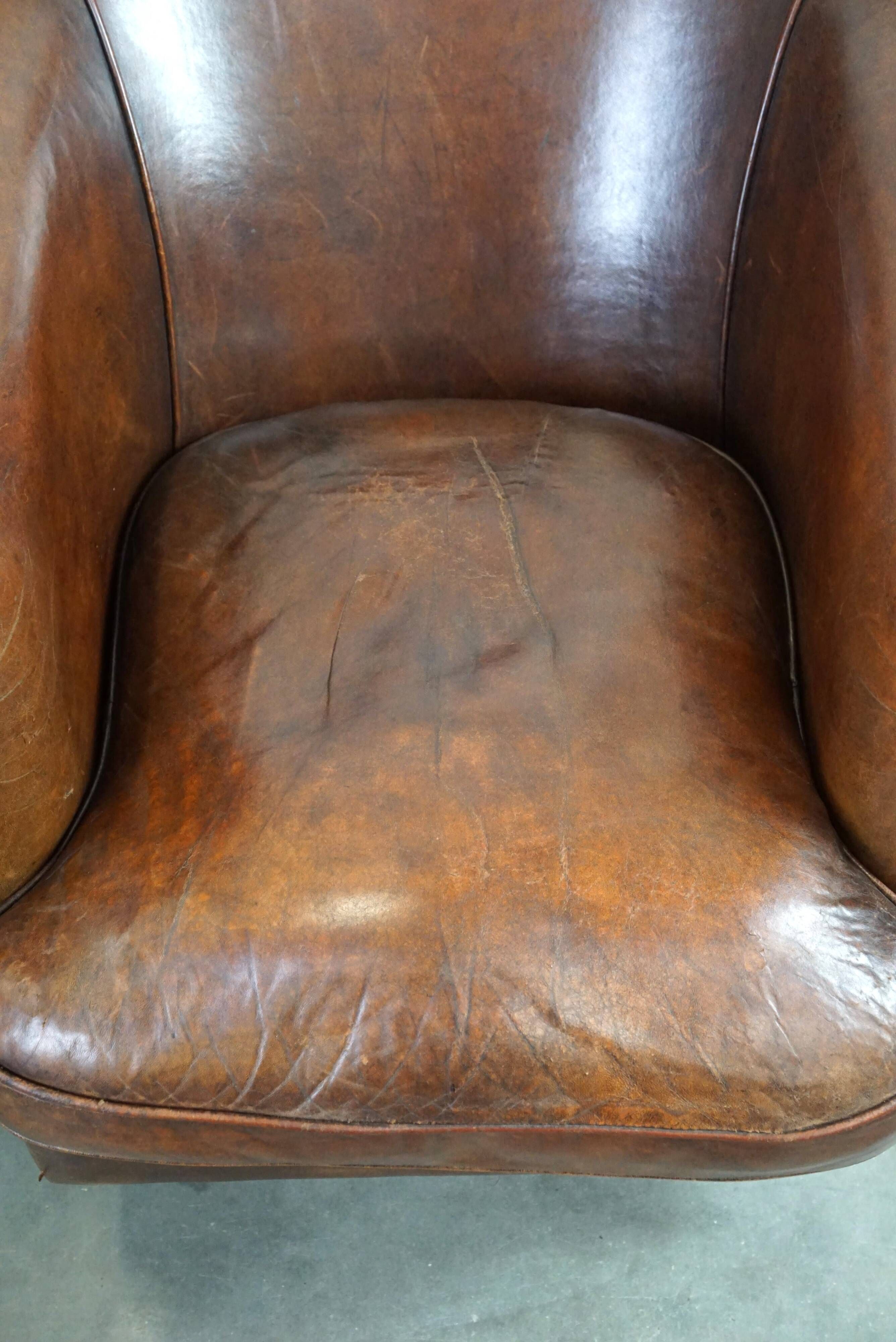 Set of two rugged sheep let of two rugged sheep leather club armchairs with a nice distressed look