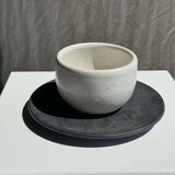 White Indonesian ceramic cup and gray saucer
