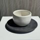 White Indonesian ceramic cup and gray saucer