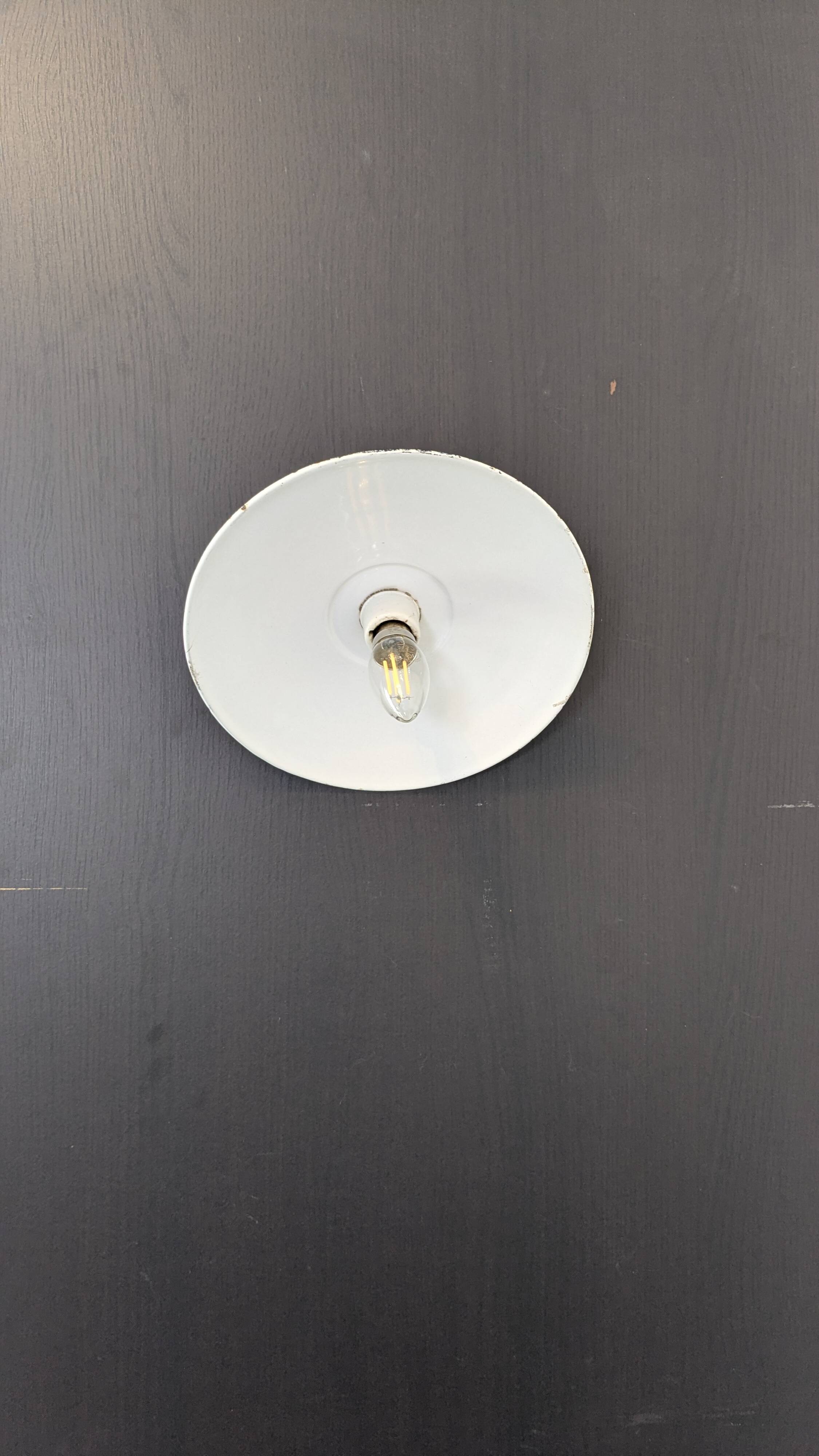 Antique wall light in blue enamel, workshop style.