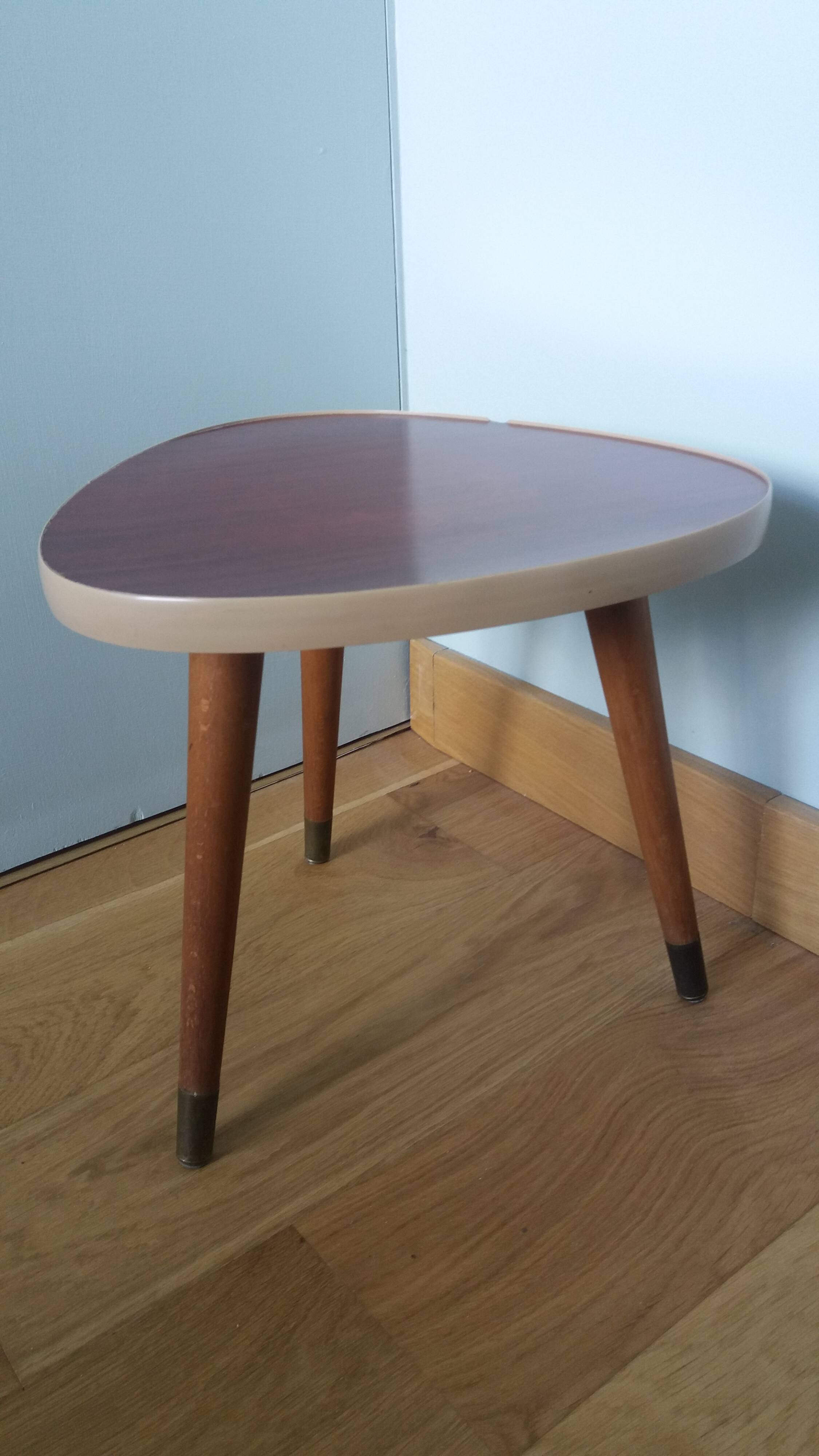 Tripod console table plant stand in the shape of a plectrum.